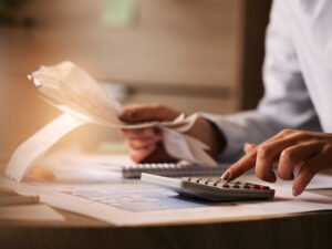 closeup-economist-using-calculator-while-going-through-bills-taxes-office.jpg